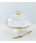 White porcelain cake dome with golden rim and cake server