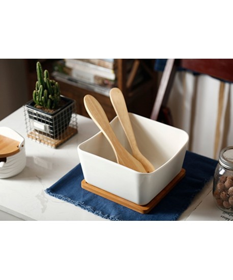 Porcelain and bamboo salad bowl with utensils